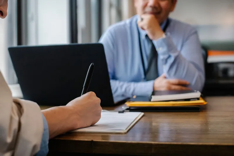 A candidate taking notes during an interview